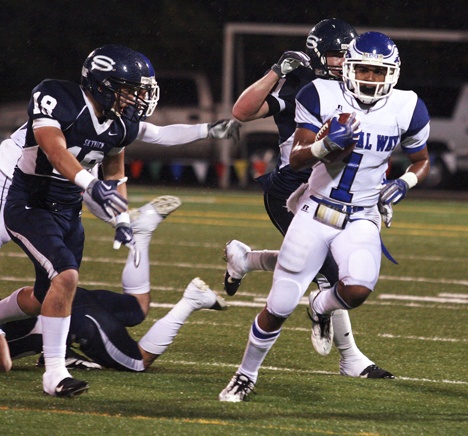 Federal Way senior receiver Alden Coleman runs with the ball after catching a pass during the first quarter against Skyview Saturday night in Vancouver. Skyview won the preliminary round state playoff game