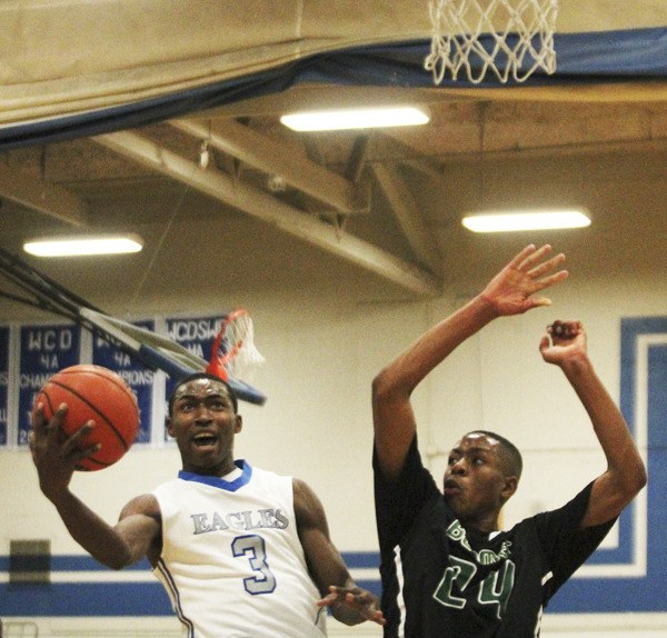 Federal Way senior D'Londo Tucker goes up for a shot against Beamer's Rayvonne Freeman during Friday night's SPSL South contest. Federal Way won the game