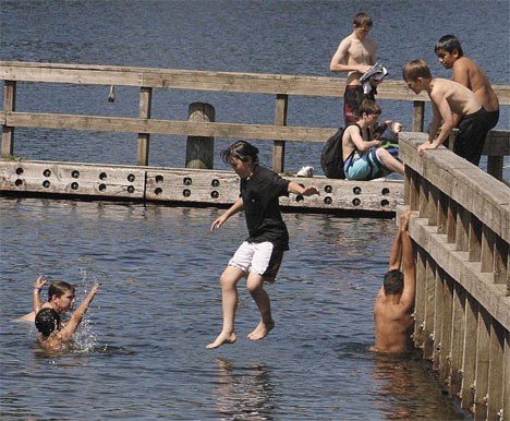 Steel Lake Park visitors enjoy the warm weather June 18. The park closes at 9 p.m. or dusk