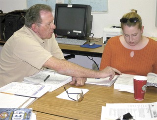 Multi-Service Center volunteer Ed DeVange helps Shawna Moore.