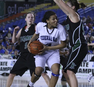 Federal Way sophomore Talia Walton battles with a pair of Kentwood defenders during Friday night's loss to the Conquerors during the Class 4A State Girls Basketball Tournament inside the Tacoma Dome. The Eagles went on to beat Moses Lake Saturday to finish third. Kentwood won the state title.