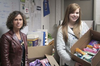 Pat Ford (left) and Alexa Tavasci hold up some of the donations the Thomas Jefferson FBLA has collected for soldiers in Iraq.