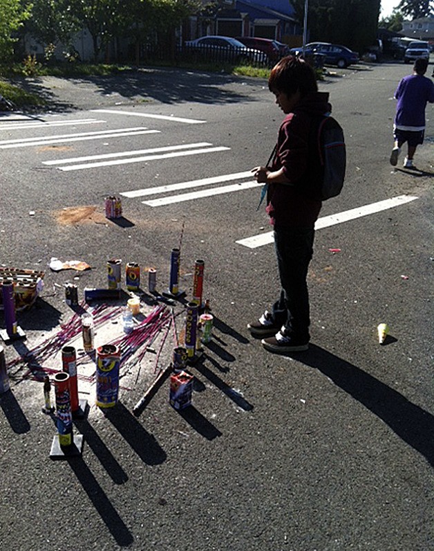 A cousin of Wayde Rodrigues-Fale stands by the accident scene Tuesday morning in Federal Way.  Wayde