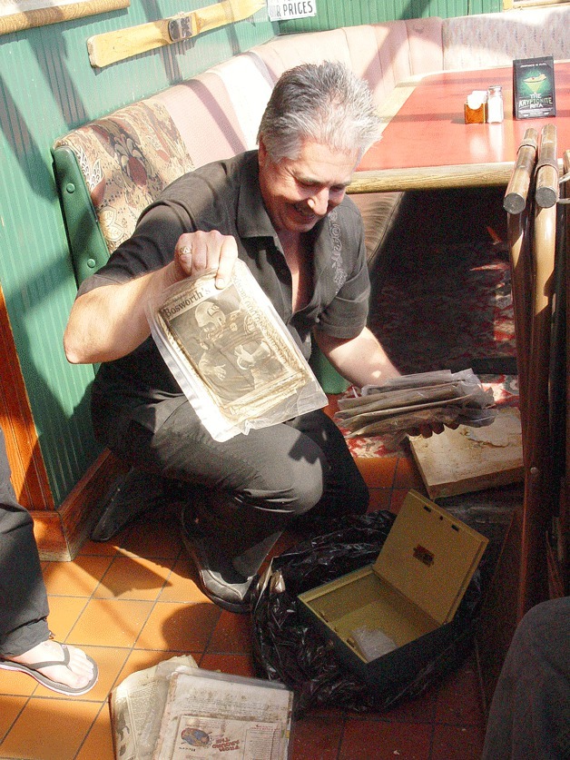 Billy McHale’s owner Jim Ross opens a 25-year-old time capsule on Wednesday. The capsule contained old newspaper clippings