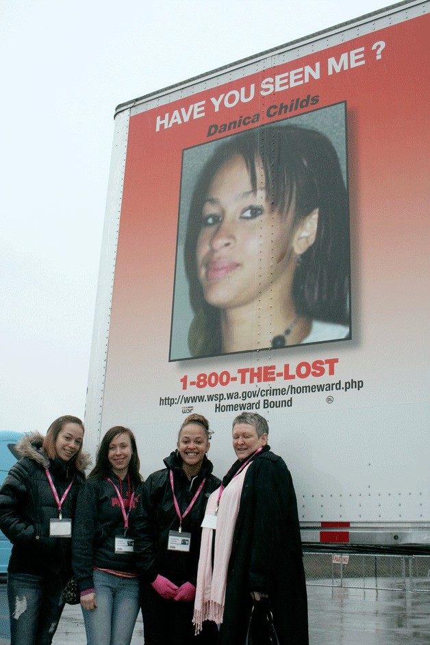 Federal Way resident Dianne Zoro (right) and her three daughters stand next to a trucking trailer at Gordon Trucking in Pacific