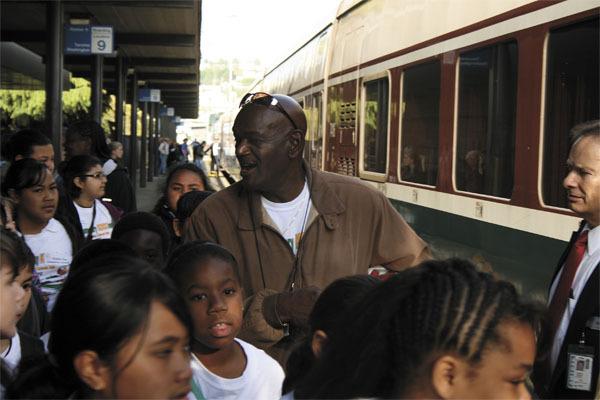 Eugene Montgomery helps Olympic View Elementary students board an Amtrak train to Portland on May 19.