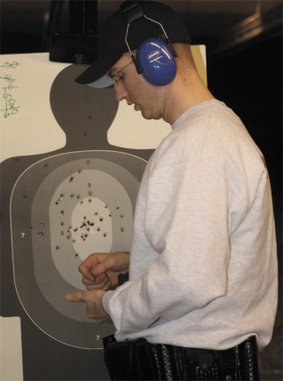 Federal Way police recruit Carl VanDyke calculates his shooting accuracy Feb. 20 at Basic Law Enforcement Academy training in Burien. A perfect score is 500. VanDyke earned a 440 during this drill.