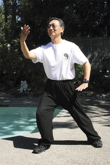 Coach Xu practices tai chi in his Federal Way backyard.