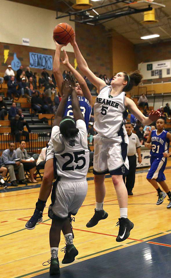 Todd Beamer junior Megan Huff blocks a shot by Federal Way's Kayla Smith during the Titans' win Friday night at Beamer. Huff finished with 18 points.