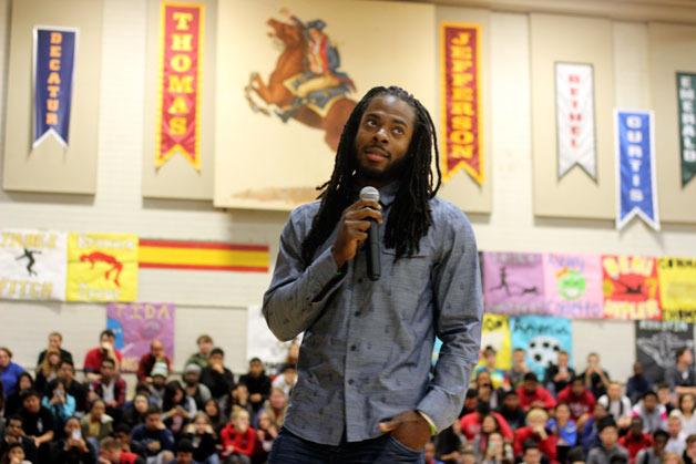 Seattle Seahawks Richard Sherman speaks to Thomas Jefferson High School students during a surprise visit to the school on Thursday.