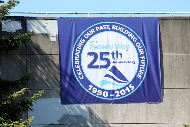 A sign near Town Square Park highlights the city’s 25th anniversary this week.