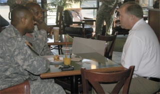 Federal Way Mayor Jack Dovey talks with U.S. Army Staff Sgt. Raymond Mobley