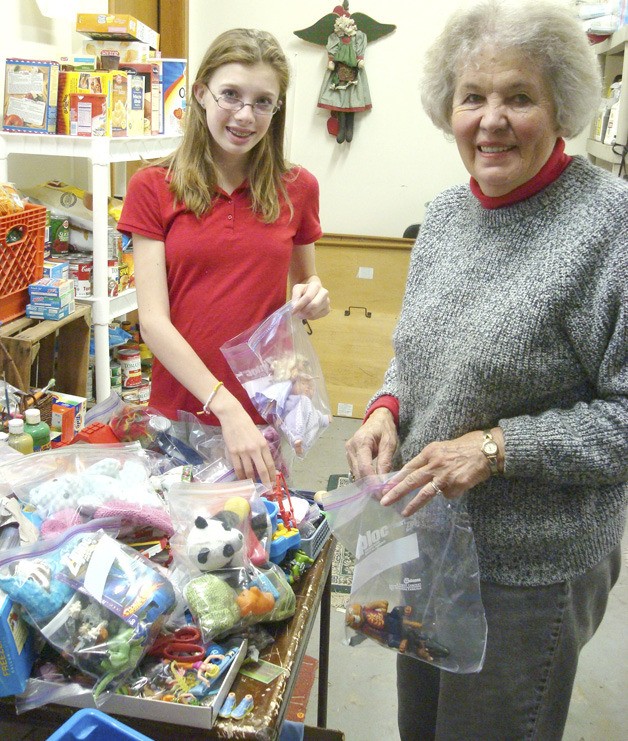Decatur High School freshman Makayla Long and her grandmother Betty Long work on stockings for Christmas House.