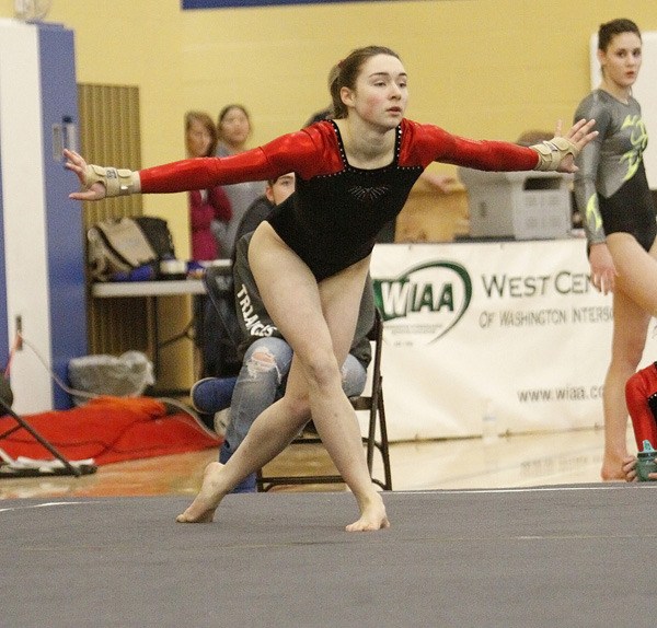 Thomas Jefferson's Madi Kellar hits a pose during her floor exercise performance Friday during West Central District III State Qualifying meet at Mt. Rainier High School. Kellar won the all-around title and helped the Raiders win the team competition.