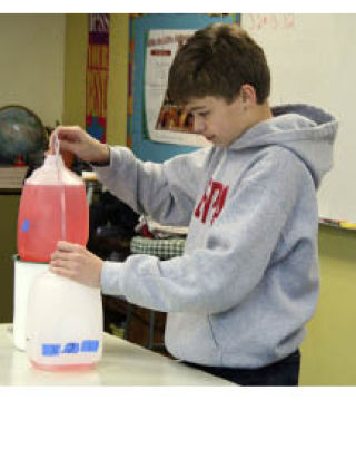 Addison Peabody watches closely while his “Jug-O-Meter” fills to the jug in just over one minute.