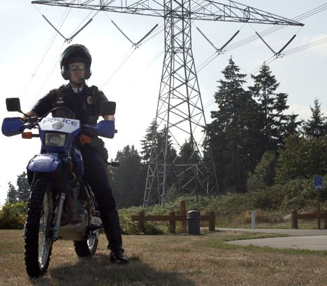 Officer Shawn Swanson is one of the Federal Way police officers certified to ride the department's dual-sport motorcycles. The vehicles can operate on and off-road and are used to patrol the city's parks and trails. Swanson is seen here in front of the BPA Trail.