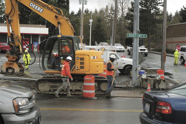 Construction crews work are seen working in April at the intersection of Pacific Highway South and South 304th Street. This fourth and final phase of construction on Pacific Highway is expected to be finished in December.