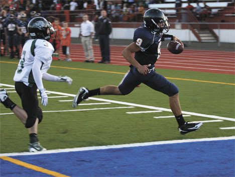 Decatur High School quarterback Aleksandr Bykovskiy crosses into the end zone for a touchdown in the first quarter Thursday against Emerald Ridge High School in their football season opener.
