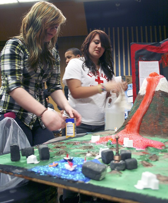 Todd Beamer High School freshmen Cassie Smith (left) and Casey Woehrle demonstrate how Mount Rainier could destroy Seattle during a science fair Wednesday.