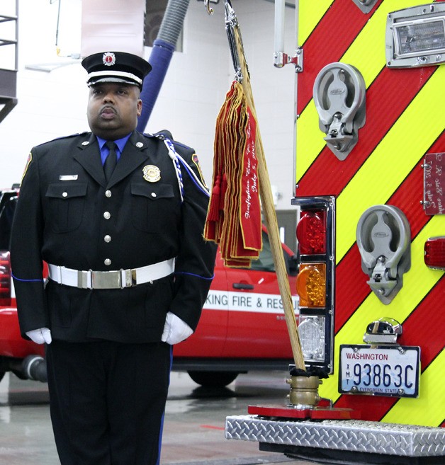 South King Fire and Rescue Lt. Barry Hassell stands at attention during a ceremony for the Memorial Pike Pole