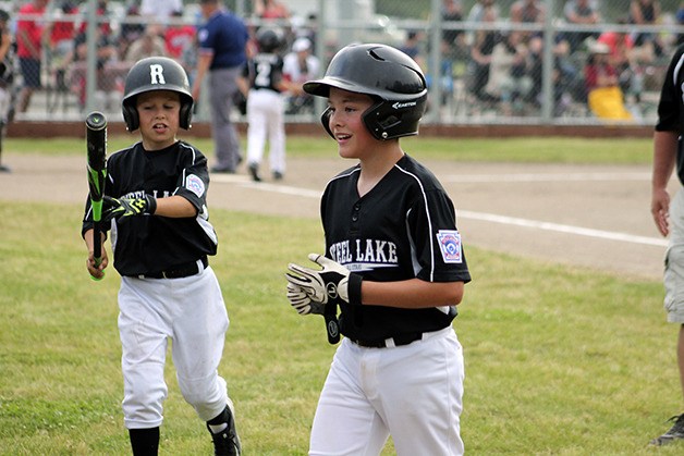 Steel Lake little leaguers share a laugh in a win over Federal Way National.