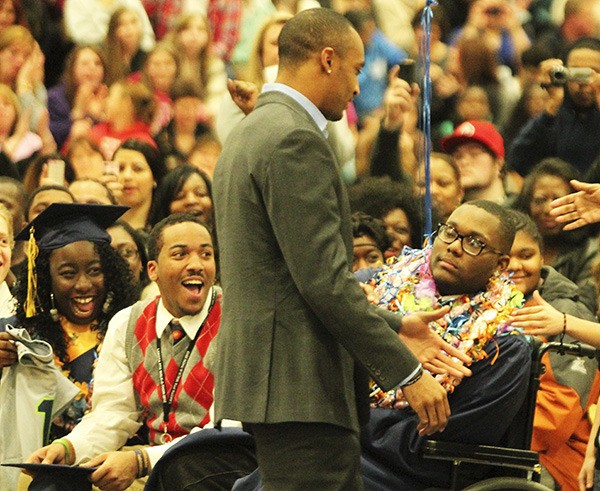 Seattle Seahawks wide receiver Doug Baldwin greets Decatur seniors Dom Cooks (glasses) and his twin sister