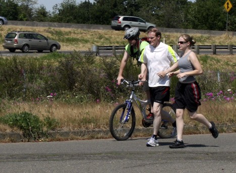 Federal Way School Board member Ed Barney ran the Seattle to Portland Bicycle Classic route last summer to raise money for Federal Way’s Elementary Track program. Here he is near Centralia with his son Mike and daughter Kim.