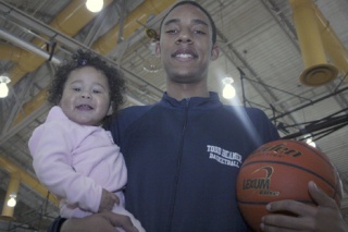 Todd Beamer High School’s Kevin Davis holds with his 1-year-old daughter