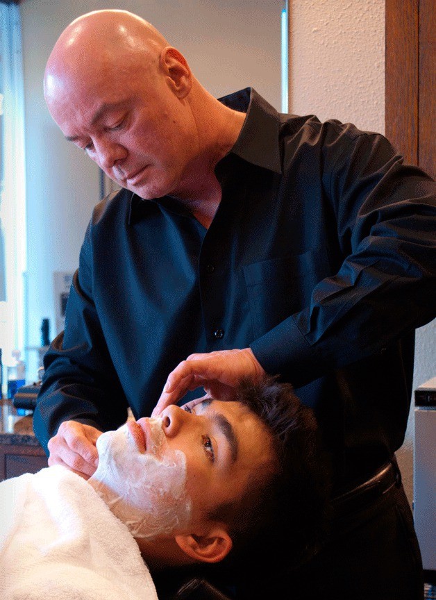 David St. John shaves a customer at the 50-year-old barber shop