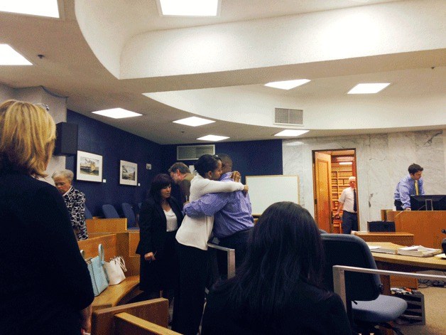 Former Federal Way School Board president Tony Moore hugs his wife after an Oregon judge sentenced him to prison at the Multnomah County Courthouse on Tuesday morning.