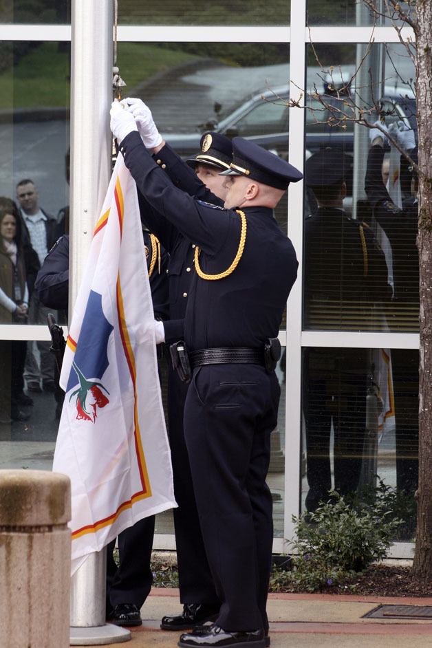 Members of the Federal Way Honor Guard raised a flag in remembrance of Officer Brian M. Walsh on Monday
