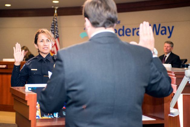 Mayor Jim Ferrell gives the oath of office to Federal Way police officer Catriona Silver during the council meeting Tuesday.