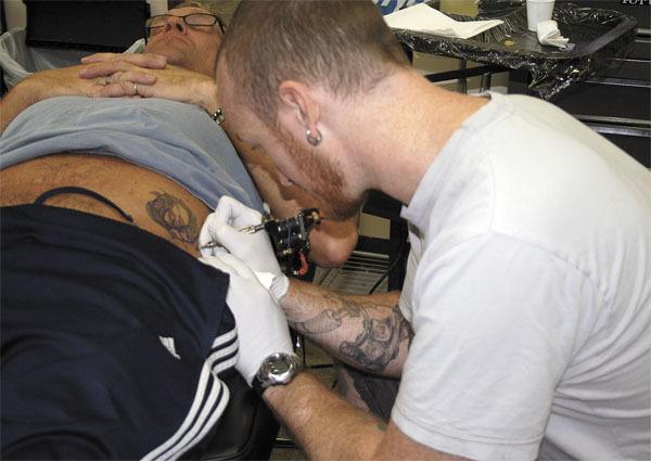 Ben Marshall reconstructs a tattoo at his Federal Way shop