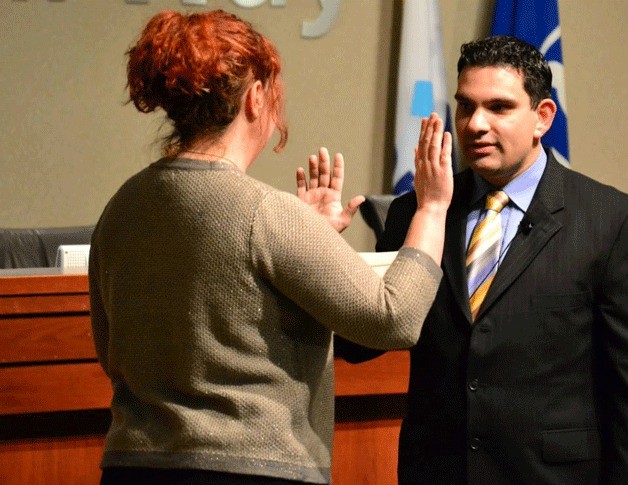 Federal Way City Councilmember Martin Moore takes the official oath of office during a private ceremony on Monday. The city will hold a public ceremony during the Jan. 7 Council meeting.