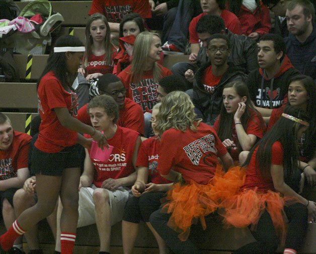 Students collect money during halftime of Friday night's basketball game for Decatur Has Heart. A majority of the students were wearing the red T-shirts.