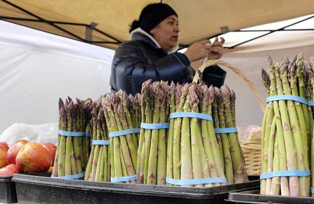 Brenda Ochoa of Yakima sells asparagus and produce on May 7 at the Federal Way Farmers Market. The market runs 9 a.m. to 3 p.m. Saturdays at 31600 20th Ave. S. (near the transit center).