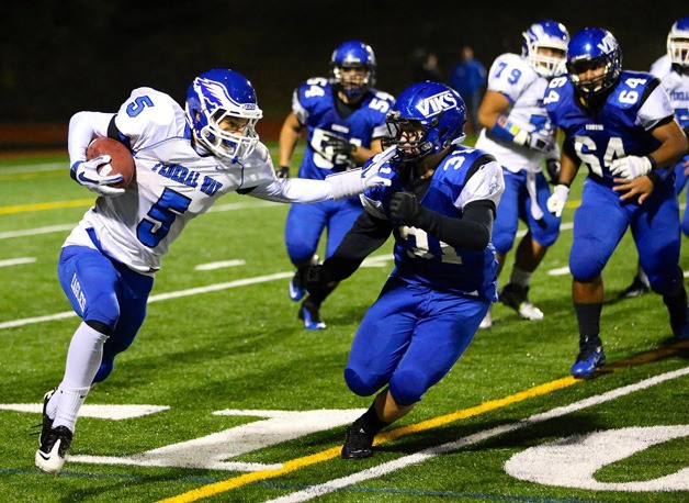 Federal Way High School's Zeek McNeal applies a stiff-arm against a Curtis defender at Friday's game.