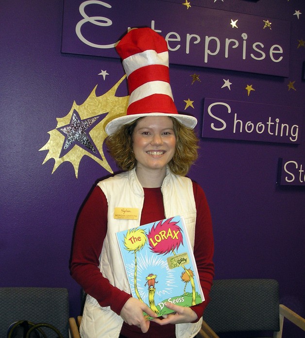 Sylvan Learning’s Morgan Griffith shows off a copy of “The Lorax” during last year’s Dr. Seuss Day celebration at Enterprise Elementary School in Federal Way.