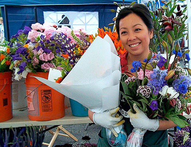 A local flower vendor from a previous Federal Way Farmers Market season. The 2015 season will open at 9 a.m. this Saturday at The Commons mall.