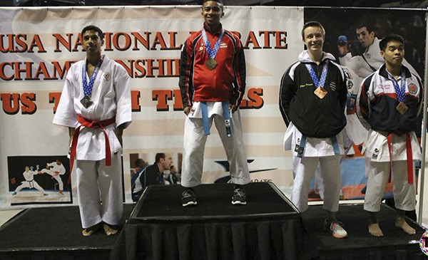 Thomas Jefferson's Kiel Hicks (center) stands atop the podium at the USA National Karate Championship after winning gold medals in the kumite and kata divisions. Hicks is the top-ranked kata expert in the world in his age group.