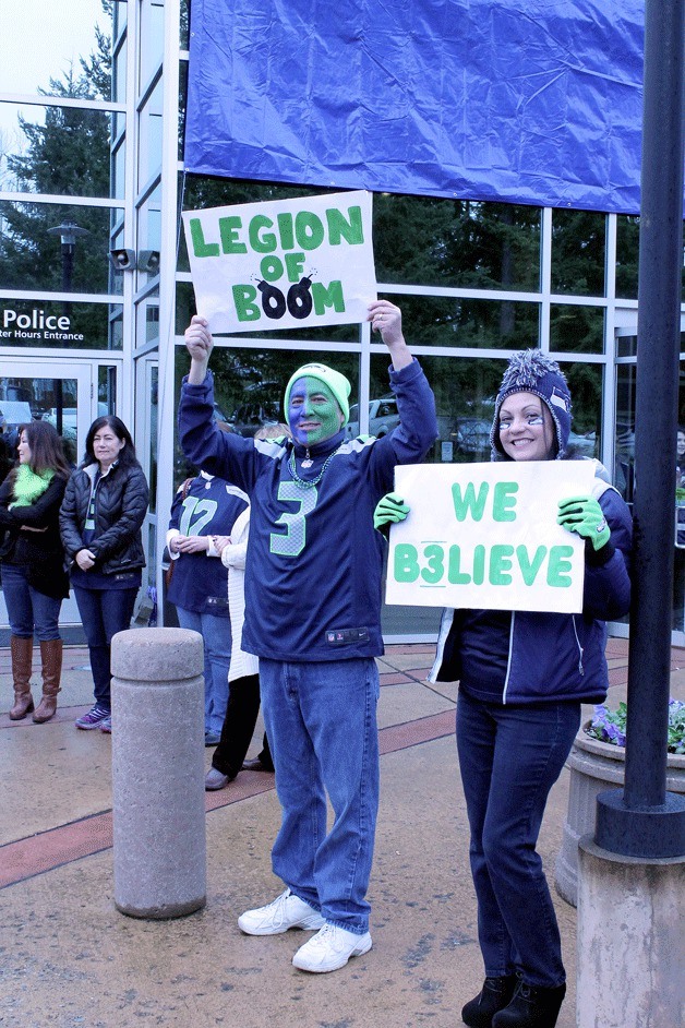 Seattle Seahawks fans hold up signs showing their support for the team during a Blue Friday rally at Federal Way City Hall on Friday.
