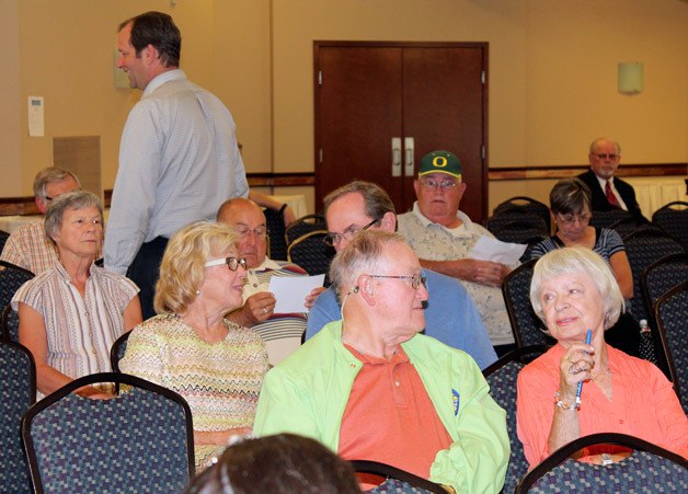 Audience members listen as candidates tackle the issues during the Mirror's candidate forum on Wednesday night at the Twin Lakes Golf and Country Club.