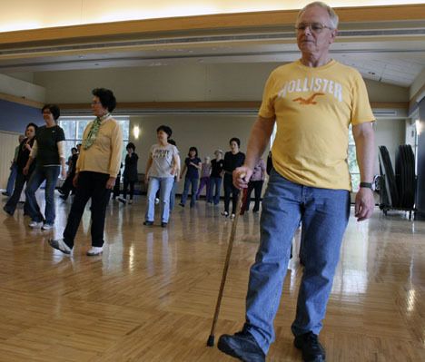 Cliff Bolstead line dances with a group of senior citizens Monday at the Federal Way Community Center. Bolstead and his wife regularly attend the line dancing class and have also tried tai chi for seniors.