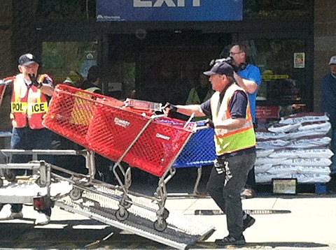 A volunteer for the Federal Way Shopping Cart Recovery Team collects carts for a local store. The team has recovered over 12