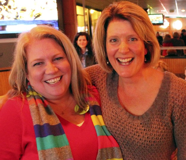 Kelly Tanner and Kris Milholland of Citizens for Federal Way Schools celebrate election night at the Scoreboard Pub after learning the capital projects levy is passing.