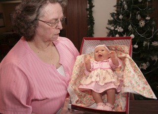 Nancy Herigstad holds one of her favorite dolls among the batch donated Dec. 17 to Multi-Service Center's Christmas House.