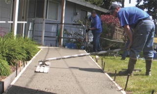 Volunteers complete a concrete ramp May 15 at Saan Ching Saeteurn's home in Federal Way as part of the annual Rampathon effort.