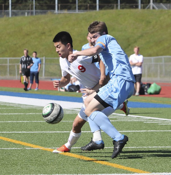 Thomas Jefferson senior midfielders Matthew Cruz goes after a ball against a Mount Rainier defender during Friday's match at Federal Way Memorial Stadium. The Raiders won 2-1 and secured the SPSL North championship.