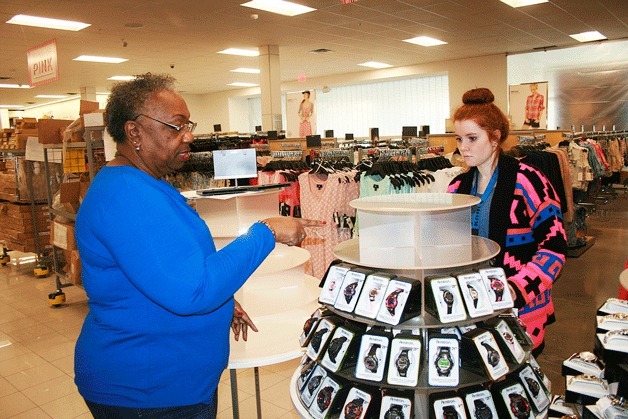 Kohl’s employees Kathleen Butler (left) and Melissa Huston (right) arrange watches on a display at the new Federal Way location as the store sets to open its doors on Friday.