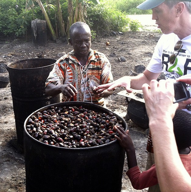 Decatur High School Principal David Brower watches as a villager processes palm oil in Ghana during a recent trip in November.